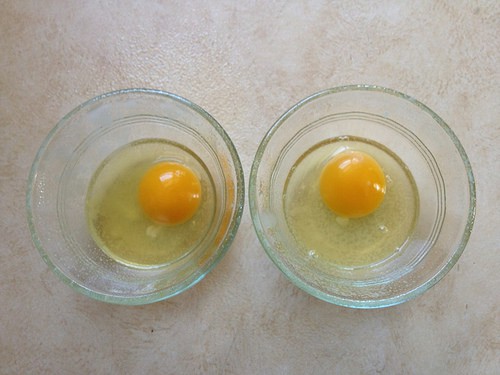 Overhead shot of two eggs in ramekins.