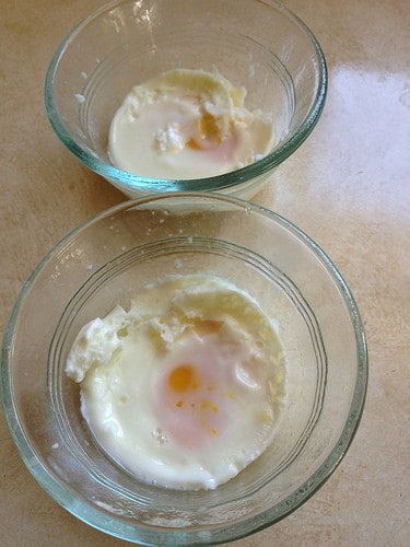Two cooked eggs in Ramekins for 1 Minute Egg Salad.
