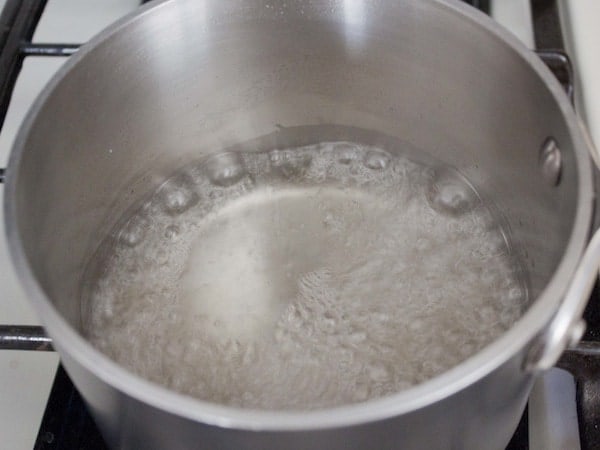 Boiling water and sugar for simple syrup.