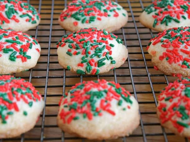 Gluten-free butter cookies with red and green sprinkles on a wire rack. 