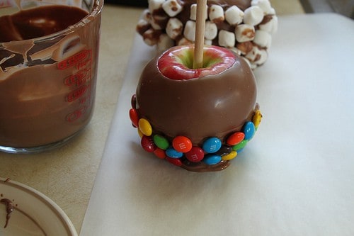 Chocolate Dipped Apples with M&M candies on the bottom.