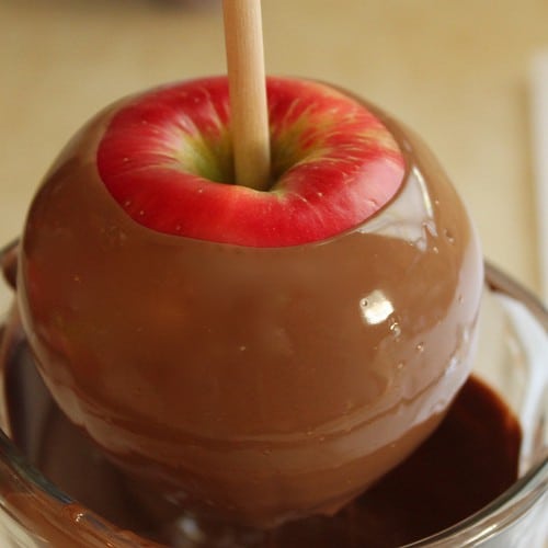 Red apple dipped in milk chocolate.