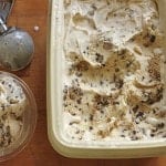 Gluten-free chocolate chip cookie dough ice cream in container.