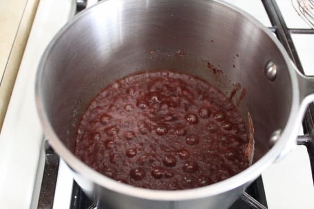Chocolate syrup boiling in pan.