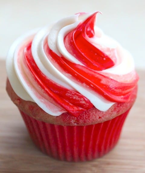 Cupcake frosted with red and white swirl of frosting.