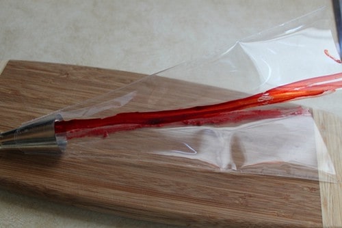Plastic pastry bag stripped with red food coloring.