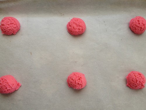 Six gluten-free sugar cookie dough rounds on a baking sheet.