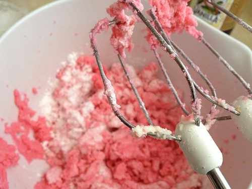 Gluten-free sugar cookie dough being mixed with a handheld mixer.
