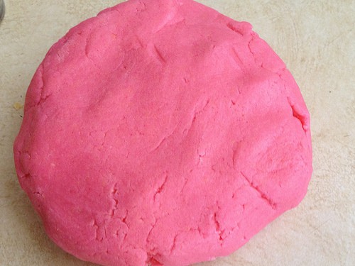 Gluten-free sugar cookie dough dyed pink in a round.