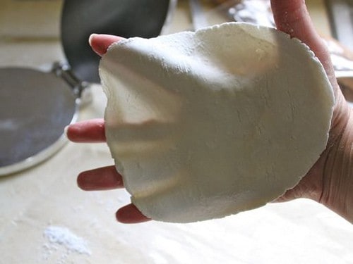 Gluten-Free Flour Tortilla dough being held in hand.