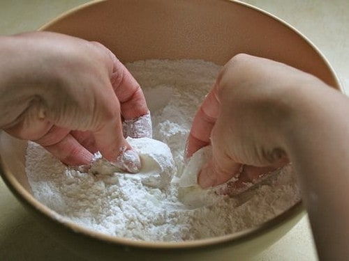 Gluten-Free Flour Tortilla dough being mixed. A pair of hands works fat into the dough.