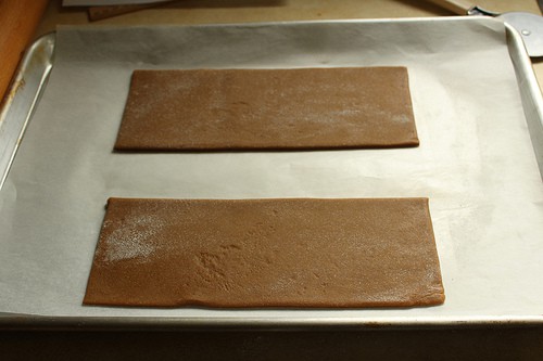 Two pieces of dough for gluten-free gingerbread house.