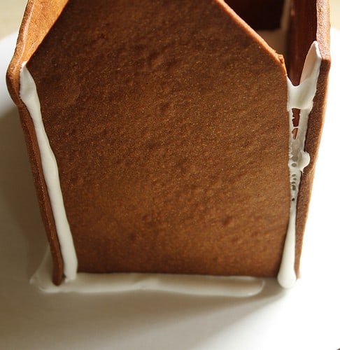 Gluten-free gingerbread house with gap on right wall.