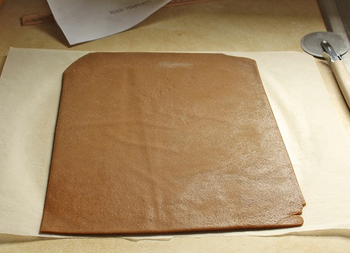 Gluten-free gingerbread dough rolled out and trimmed into a large square.