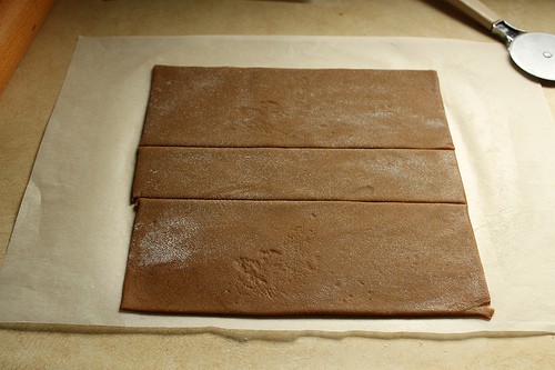 Gluten-free gingerbread dough cut into three rectangles.