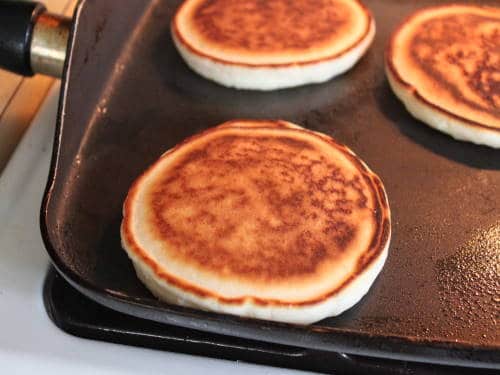 Gluten-free pancakes on skillet.