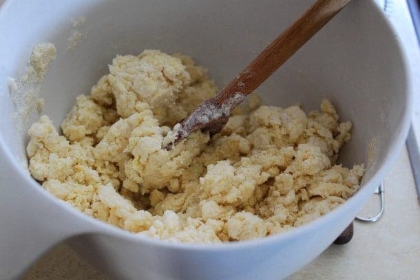 Gluten-free pizza dough being mixed in a bowl.