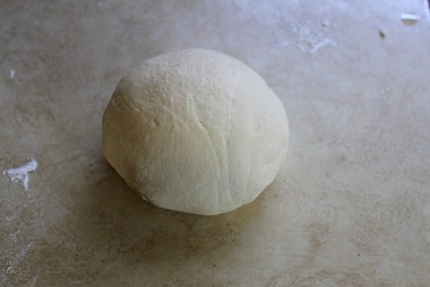 Gluten-free pizza dough ball on a counter.