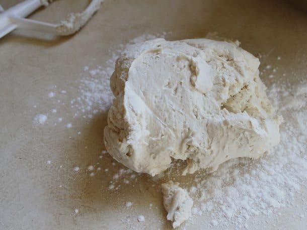 Gluten-Free Soft Pretzel dough on a flour covered counter.