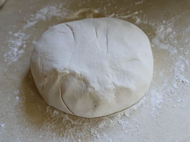 Gluten-Free Soft Pretzel dough on a white rice flour coated counter.