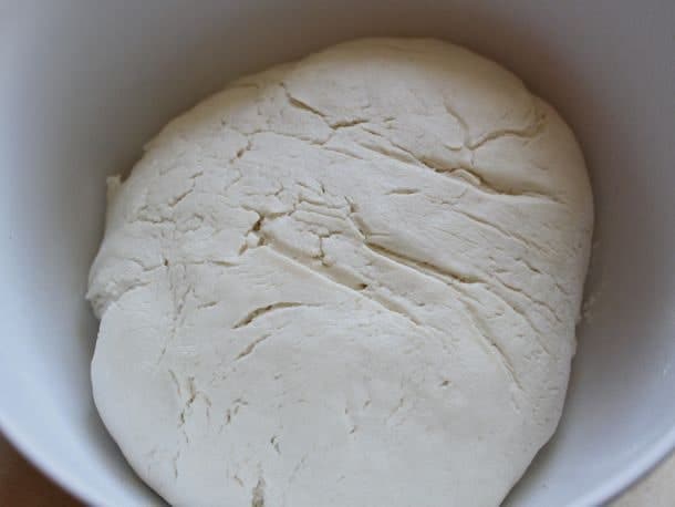 Gluten-Free Soft Pretzel dough risen in a white bowl.