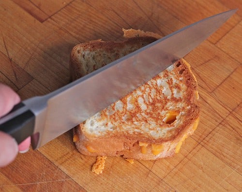 Slicing a gluten-free grilled cheese.