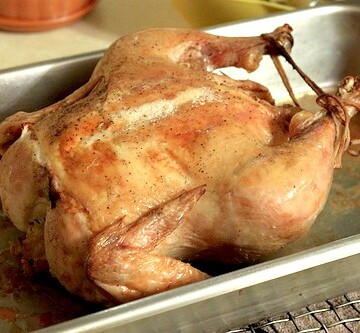 Roasted chicken in pan.