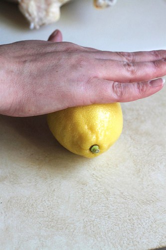 Rolling lemon on a counter.