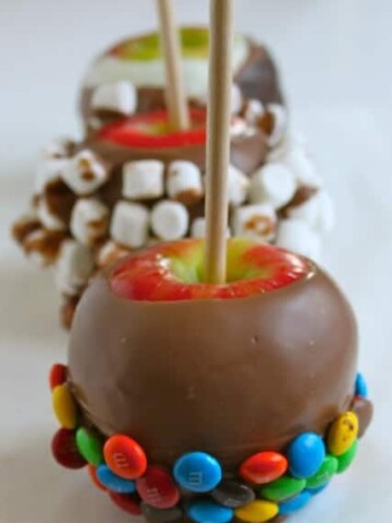 Chocolate dipped apple with M&M candies on the bottom.
