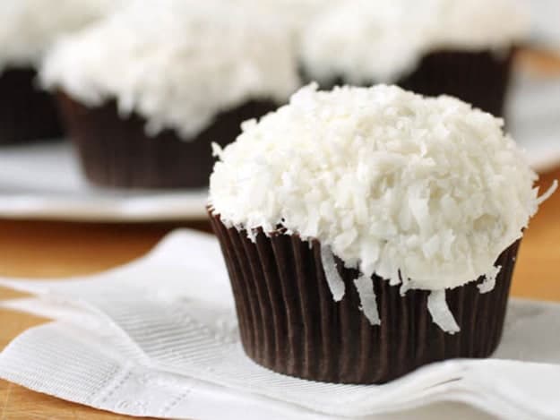 Gluten-free chocolate cupcake frosted with buttercream and topped with shredded coconut.