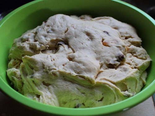 Gluten-free panettone dough risen in green bowl.