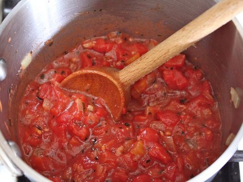 Pizza sauce with chunky tomatoes in a pot.