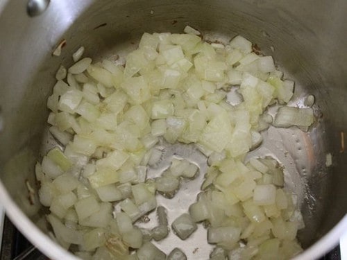 Chopped onions cooking in pot.