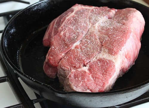 Chuck roast in pan with salt.