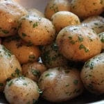 Steamed potatoes coated in butter and herbs.