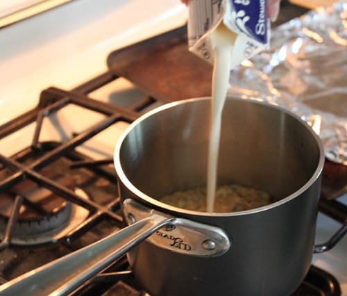 Pouring cream into pot with caramel sauce.