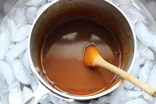 Caramel sauce in pot, cooling in an ice bath.