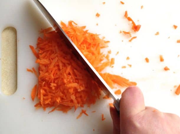 Chopping carrots for gluten-free spinach dip.