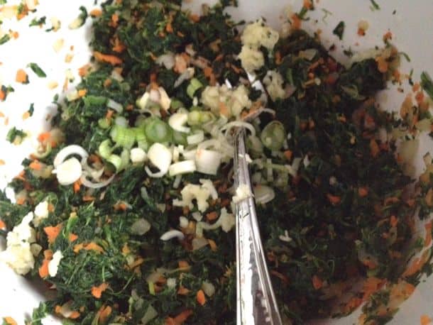 Mixing ingredients for gluten-free spinach dip.