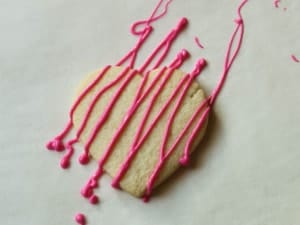 Gluten-free heart cookie with pink chocolate drizzle.