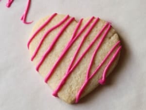 Gluten-free heart cookie with pink chocolate drizzle.