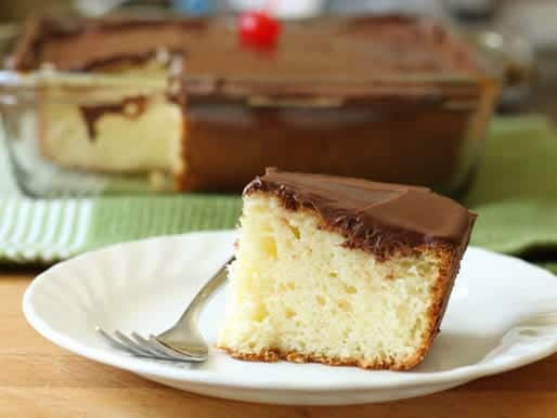 Gluten-Free Yellow Cake slice on white plate.