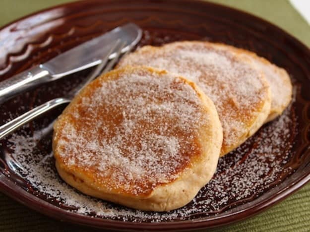 Apple Cider Doughnut Pancakes on a plate coated with granulated sugar.