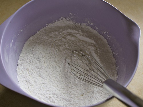 Whisking flour for gluten-free chocolate chip pancakes.