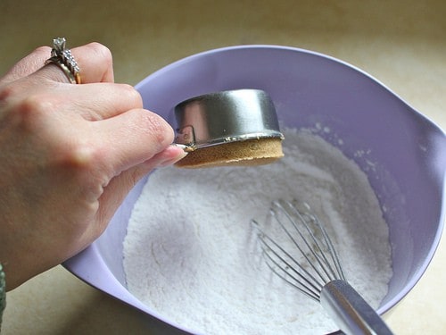 Adding brown sugar to gluten-free flour mixture.