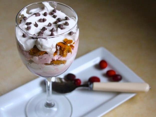 Thanksgiving Cranberry Trifle in a wine glass. Topped with whipped cream and chocolate chips.