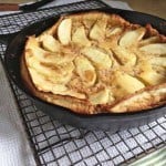 Gluten-Free Dutch Apple Pancake in a skillet set on a cooling rack.