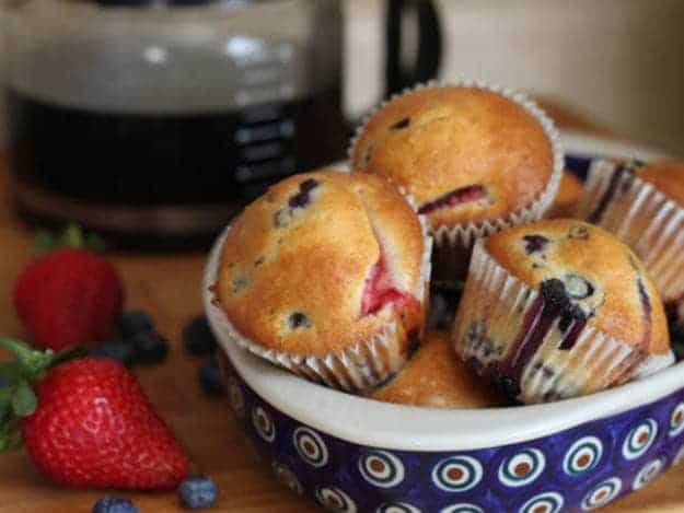 Gluten-Free Berry Muffins in a ceramic basket.