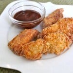 Gluten-Free Crispy Chicken Fingers on a white plate.