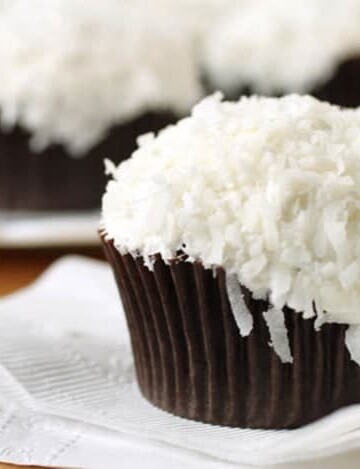 Gluten-free chocolate cupcake frosted with buttercream and topped with shredded coconut.